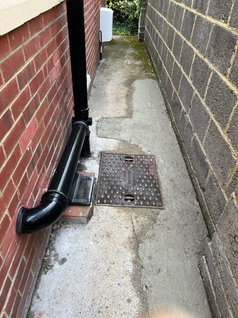 Recently concreted path after fixing a blocked drainpipe