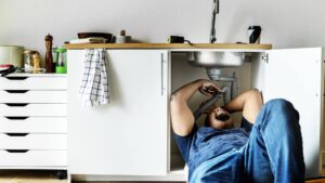 Plumber unblocking a sink